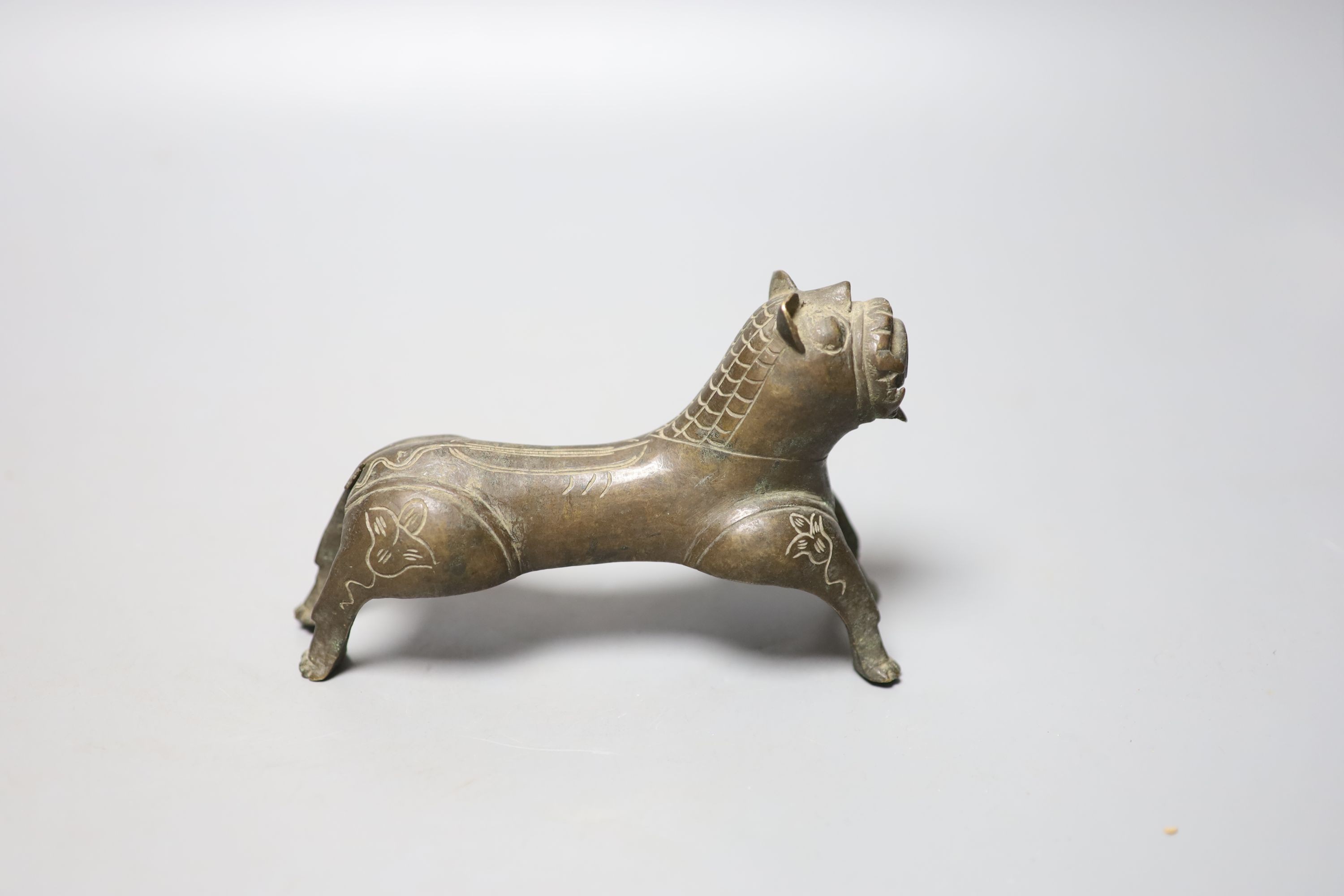 A Persian bronze tiger figure with incised detail, 16cm